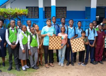 Students from four schools pose with chess boards during the interschool chess tournament hosted by Isaac A. David Memorial High School in Paynesville