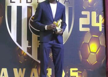 Liberian football player poses with trophy during the Liberia Football Association End-of-Season Awards ceremony