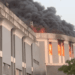 Smoke and flames engulf the Capitol Building during the December fire at the center of the ongoing arson trial in Monrovia.