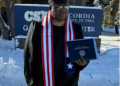 Charles Paul Vah II poses with his MBA diploma after graduating from Concordia University in St. Paul, Minnesota.