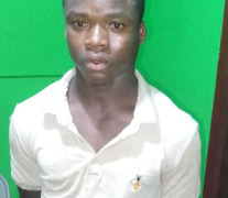 A suspect stands at a police station in Margibi County following an arrest in a child kidnapping investigation.