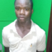 A suspect stands at a police station in Margibi County following an arrest in a child kidnapping investigation.