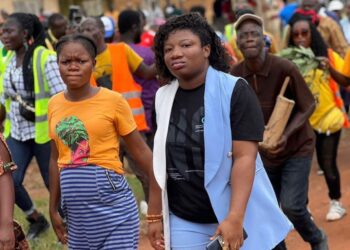 Liberian activist Abigail Freeman walking among community members in Nimba County during outreach activities before receiving online threats over her anti-FGM advocacy