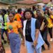 Liberian activist Abigail Freeman walking among community members in Nimba County during outreach activities before receiving online threats over her anti-FGM advocacy