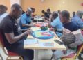 Players seated in a tournament hall during Scrabble Mania 3.0 in Monrovia, Liberia