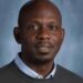 Dr. George Wah Williams, author of the ALT governance reform paper, photographed in a professional portrait setting