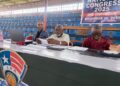 Liberia Basketball Association officials seated at the 2025 policy congress at SKD Gymnasium reviewing documents during the session.