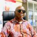 A man wearing sunglasses and a patterned shirt seated in an office, identified as UP Margibi fundraising chair Ben A. Fofana.