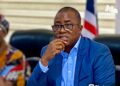 Former LTA Chair Abdullai Kamara seated in a courtroom setting during legal proceedings, appearing thoughtful as corruption charges against him advance to Buchanan
