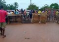 Residents of Suakoko District block the Gbarnga–Monrovia Highway with wooden barricades during a protest demanding justice for the death of Quita Jackson.