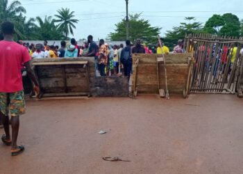 Residents of Suakoko District block the Gbarnga–Monrovia Highway with wooden barricades during a protest demanding justice for the death of Quita Jackson.