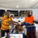 ArcelorMittal Liberia representative presents a donation cheque to county officials in support of the National County Sports Meet.