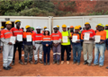 Certified ArcelorMittal Liberia mine operators displaying competency certificates at Yekepa mine site