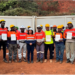 Certified ArcelorMittal Liberia mine operators displaying competency certificates at Yekepa mine site