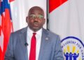 CMC leader Musa H. Bility speaks at a podium as he promotes proposed legislation to help African-Americans make Liberia a second home.