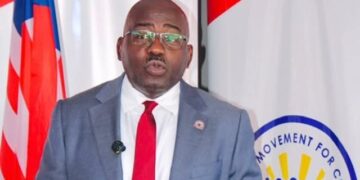 CMC leader Musa H. Bility speaks at a podium as he promotes proposed legislation to help African-Americans make Liberia a second home.