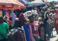 Traders sell clothes and household items in a busy Monrovia market as vendors complain of slow sales and a cash crunch.