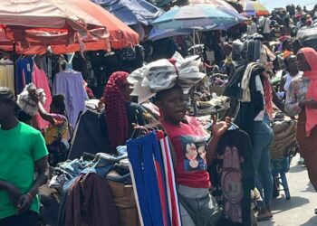 Traders sell clothes and household items in a busy Monrovia market as vendors complain of slow sales and a cash crunch.