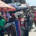Traders sell clothes and household items in a busy Monrovia market as vendors complain of slow sales and a cash crunch.