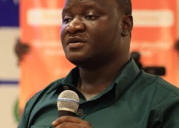 Liberia Football Association official Joel Freeman speaks at a football event amid reports of a three-month suspension over transfer window violations.