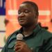 Liberia Football Association official Joel Freeman speaks at a football event amid reports of a three-month suspension over transfer window violations.