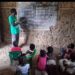 A deteriorating public school building and pupils studying in an unfinished classroom in Todee District, Montserrado County.