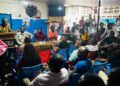 Audience gathered in a crowded room listening to a speaker at a Naymote public forum discussion on governance and accountability in Monrovia