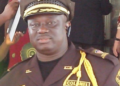 Liberia Immigration Service officer in uniform during a regional meeting in Bomi County where LIS announced plans to build rural housing for officers in western Liberia.
