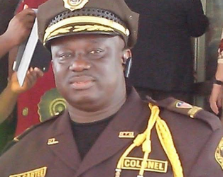 Liberia Immigration Service officer in uniform during a regional meeting in Bomi County where LIS announced plans to build rural housing for officers in western Liberia.