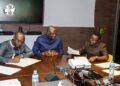 Officials of the Central Bank of Liberia review documents during a meeting on mobile money regulation and the rollout of the Inclusive Instant Payments System in Monrovia.