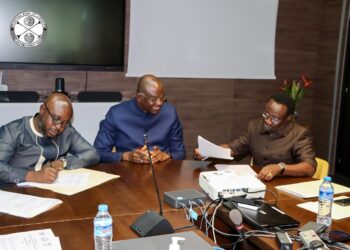 Officials of the Central Bank of Liberia review documents during a meeting on mobile money regulation and the rollout of the Inclusive Instant Payments System in Monrovia.