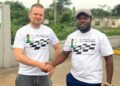 Slovak International Master Stefan Macak shakes hands with Liberia chess official during his Liberia tour