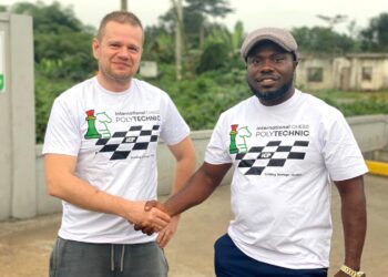 Slovak International Master Stefan Macak shakes hands with Liberia chess official during his Liberia tour