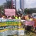 Dock workers protest at Capitol Hill holding a banner urging President Boakai to veto port autonomy bills