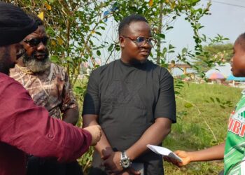 Upjit Singh Sachdeva presents cash donation to Margibi County kickball team after victory over Nimba