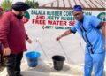 Jeety Rubber and Salala Rubber Corporation officials, including Margibi Superintendent O. Jay Morris, test a newly dedicated free borehole tap providing clean drinking water in Weala, Margibi County.