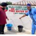 Jeety Rubber and Salala Rubber Corporation officials, including Margibi Superintendent O. Jay Morris, test a newly dedicated free borehole tap providing clean drinking water in Weala, Margibi County.