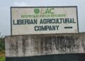 Signboard of the Liberian Agricultural Company (LAC) at the entrance to its concession area in Grand Bassa County, Liberia.