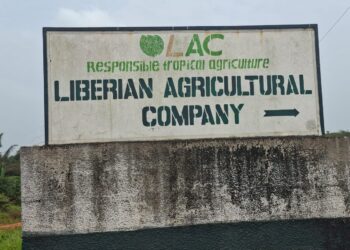 Signboard of the Liberian Agricultural Company (LAC) at the entrance to its concession area in Grand Bassa County, Liberia.