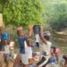 Residents of Morris Farm Community in Todee District, Rural Montserrado County, fetch water and wash clothes at a creek along the Du River due to limited access to hand pumps.