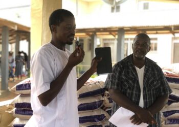 Diaspora representatives distribute rice rations to volunteer health workers at James Jenkins Dossen Memorial Hospital in Harper