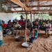 Trainer Jacob B. Dennis instructs youth trainees during a hands-on agriculture session at the Youth International Training Institute farm near Gbarnga.