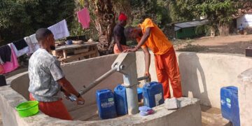 inmates fetching water at the community water pump