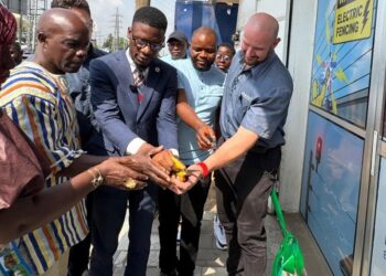 Officials and company representatives cut a ribbon during the opening of Liberian-owned P&D Electric, an electric fencing firm, in Paynesville.