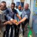 Officials and company representatives cut a ribbon during the opening of Liberian-owned P&D Electric, an electric fencing firm, in Paynesville.