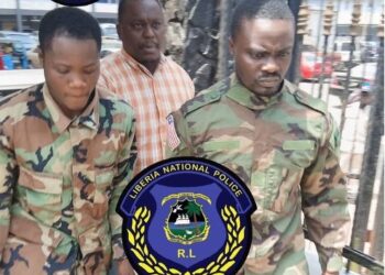 Liberia National Police escort suspects accused of posing as AFL soldiers