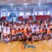 Young athletes posing during Flames Basketball Academy training program launch