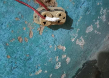 Exposed electrical outlet inside a residence in Pleebo City where a child died in a suspected electrocution incident.