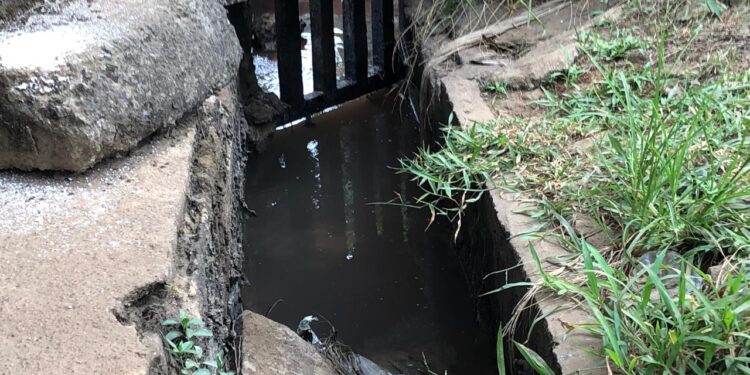Drainage channel in Morris Farm community where residents suspect industrial discharge from nearby brewery operations