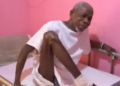 Former Chief Zoe Zanzan Karwor seated on hospital bed during illness